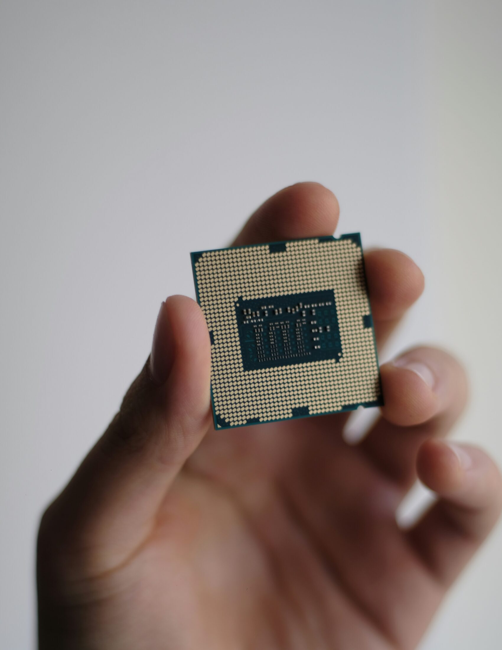 Man holding a Semiconductor Chip - Silicon - We specialize in Semiconductor Technical Recruitment Solutions